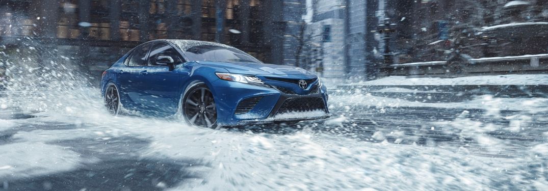 Blue 2020 Toyota Camry with AWD Driving in Snow