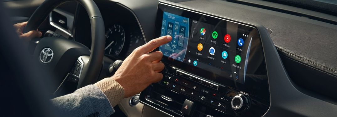 Close Up of Man Using 2020 Toyota Highlander Toyota Entune 3.0 Touchscreen Display