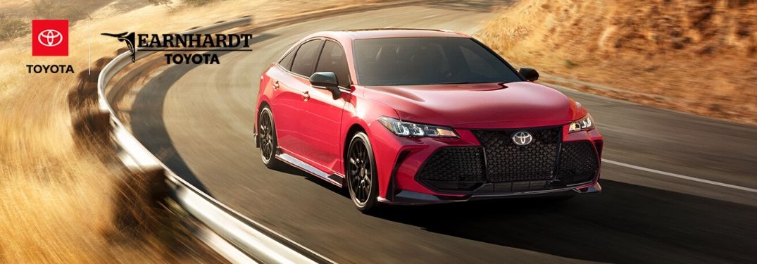 Red 2020 Toyota Avalon on Country Road with Earnhardt Toyota Logo in Upper Left Corner