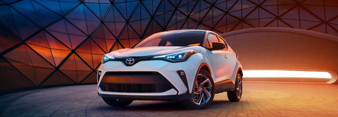 White 2020 Toyota C-HR in Front of Modern Building at Sunset