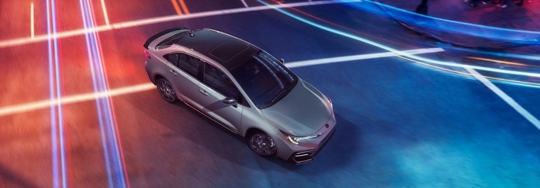 Overhead View of Silver 2021 Toyota Corolla Apex Edition on Colorful Street