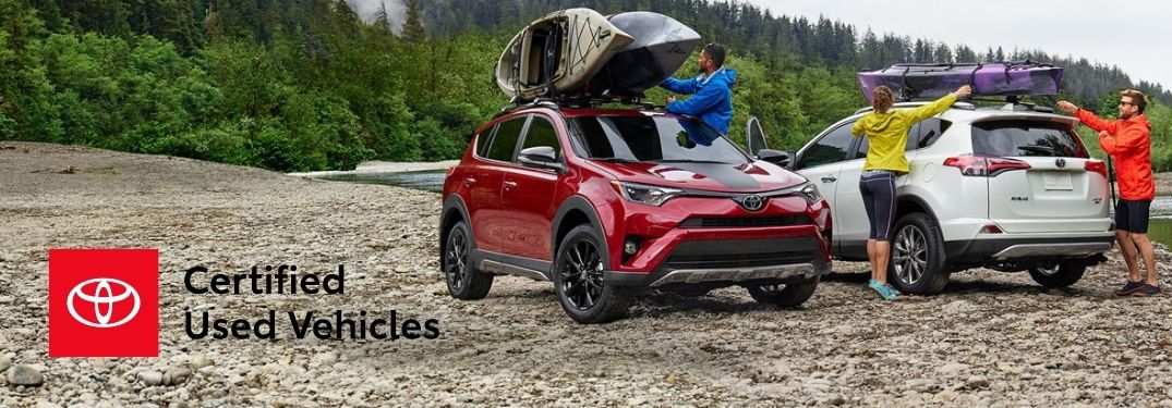 Red and White Toyota RAV4 Models Next to a Lake with Toyota Certified Used Vehicle Logo in Lower Left