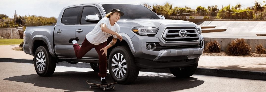 Silver 2021 Toyota Tacoma and Skateboarder on a City Street