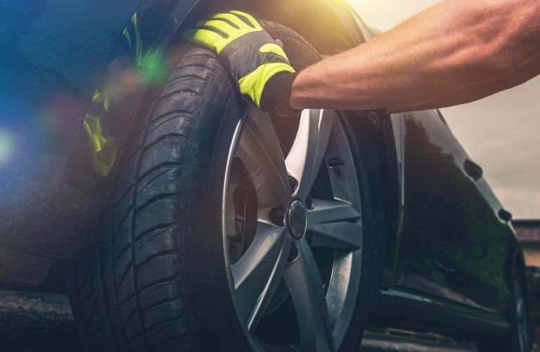 Mechanic Replacing a Tire on a Car