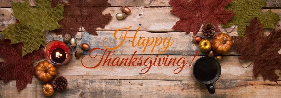 Leaves on a Table with Orange and Red Happy Thanksgiving Text