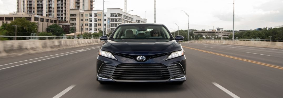 Blue 2021 Toyota Camry Front Exterior on a Freeway