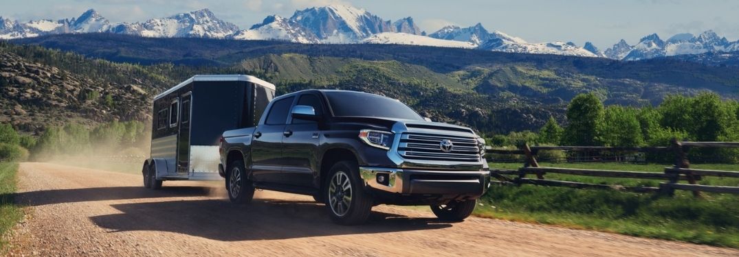 Black 2021 Toyota Tundra Towing a Trailer on a Country Road