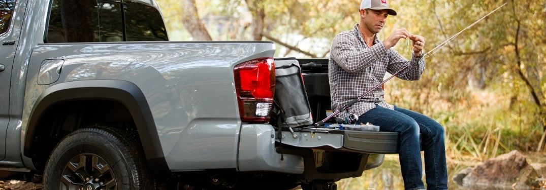 Man Sitting on the Tailgate of Gray 2021 Toyota Tacoma
