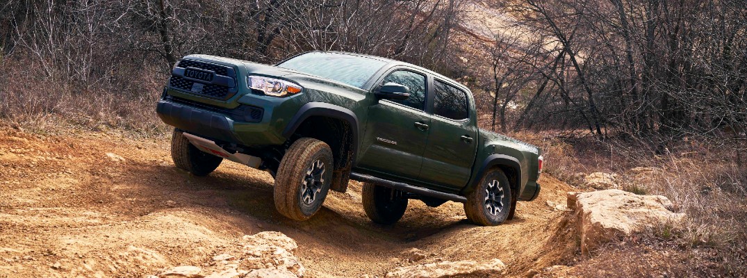 A photo of the 2021 Toyota Tacoma climbing rocks.