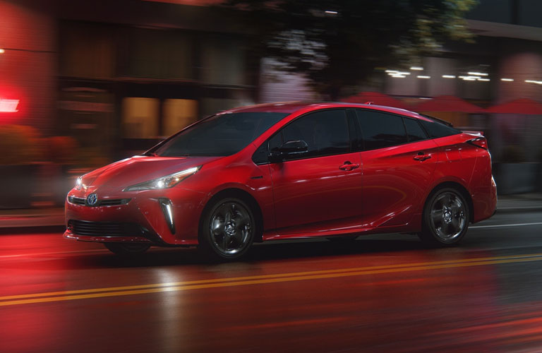 Red 2021 Toyota Prius on City Street at Night
