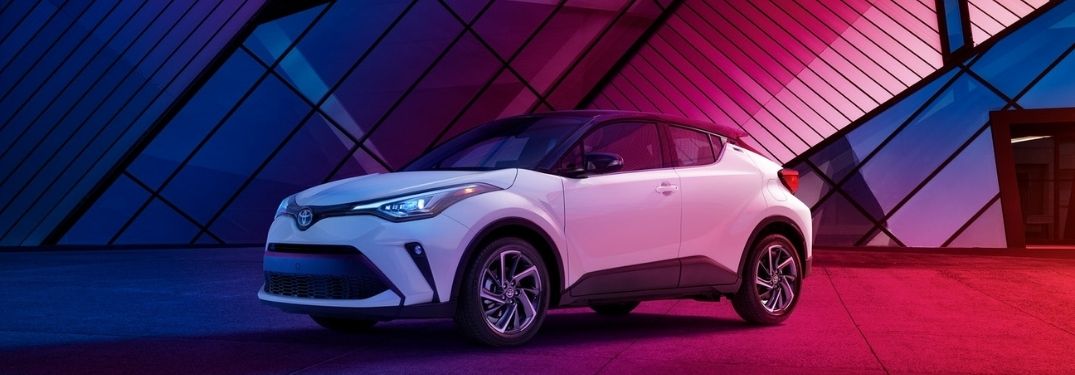 White 2021 Toyota C-HR Next to Colorful Modern Building