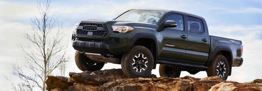 Green 2021 Toyota Tacoma with Lift Kit on Rock Formation