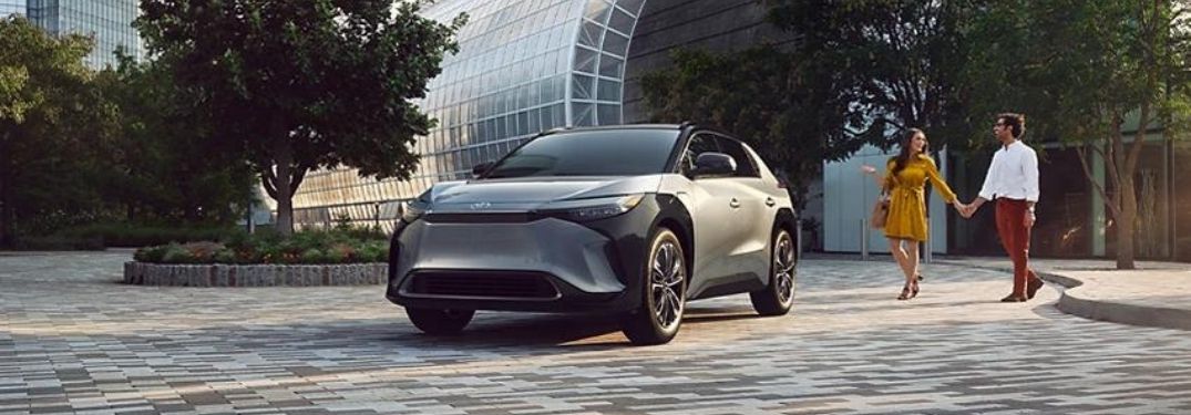 Gray 2023 Toyota bZ4X Front Exterior and Couple in a Parking Lot