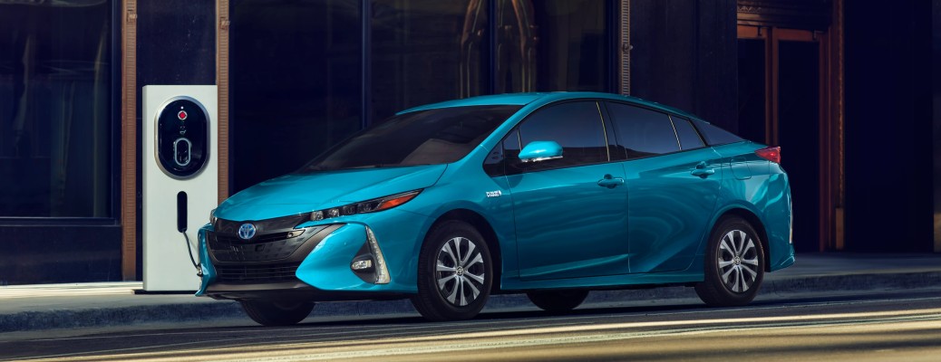A 2022 Prius Prime in blue charging at a fast charging station