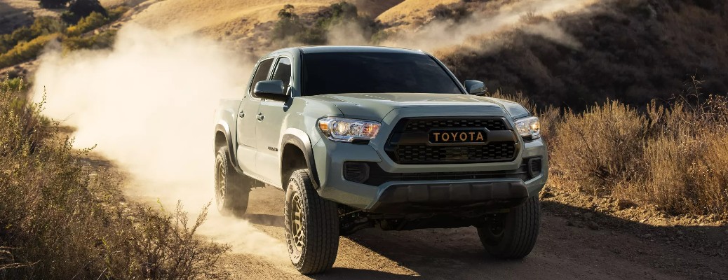 A 2022 Toyota Tacoma driving down a dirt road